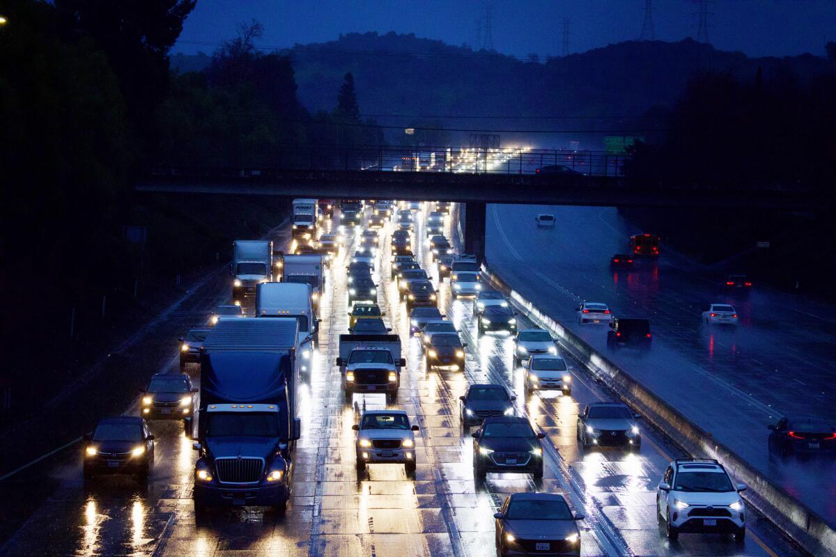 Commuters navigate heavy traffic on rain-slicked westbound 210 Freeway through Azusa on Feb. 1.