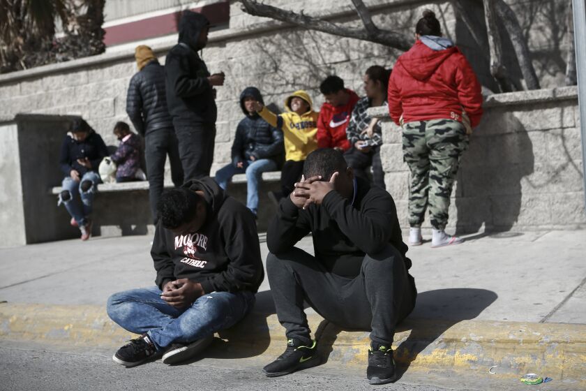 Migrants grieve in front at a Mexican immigration detention center in Ciudad Juarez, Mexico, Tuesday, March 28, 2023, where a fire in a dormitory left more than three dozen migrants dead. President Andrés Manuel López Obrador said the fire was started by migrants in protest after learning they would be deported. (AP Photo/Christian Chavez)