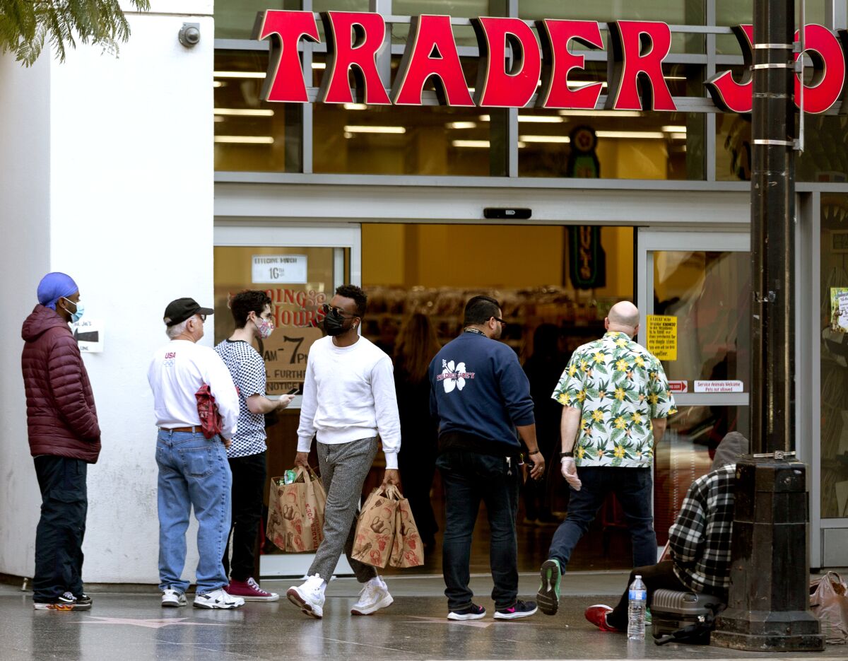 People stand in line outside a Trader Joe's in Hollywood.
