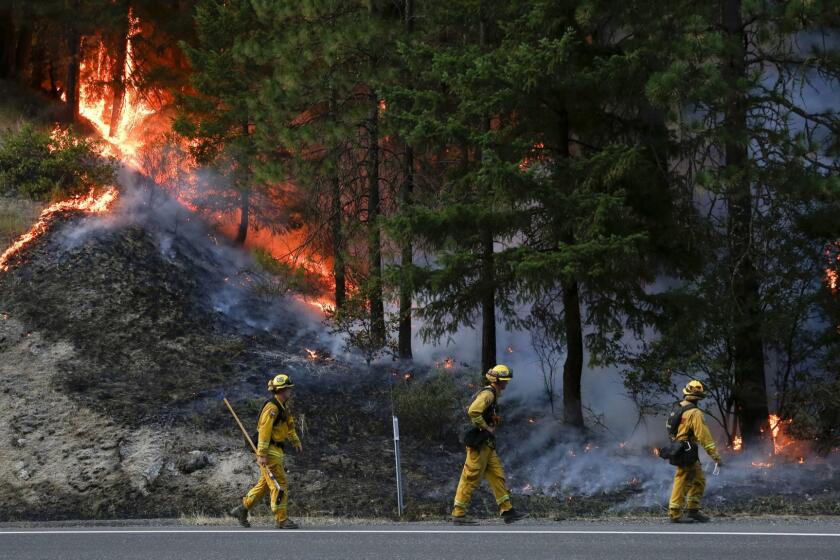 REDDING, CA - JULY 30: CalFire firefighters monitor flames above State Highway 299 while battling the Carr Fire on July 30, 2018 west of Redding, California. Six people have died in the massive fire, which has burned over 100,000 acres and forced thousands to evacuate since it began on July 23. (Photo by Terray Sylvester/Getty Images) ** OUTS - ELSENT, FPG, CM - OUTS * NM, PH, VA if sourced by CT, LA or MoD **