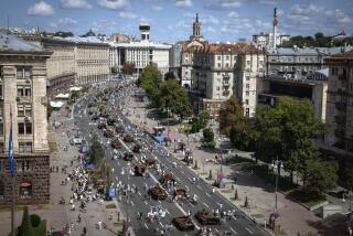 People look at a large column of burnt out and captured Russian tanks and infantry carriers which have been on display on the central Khreshchatyk boulevard as Ukrainians mark Independence Day, in Kyiv, Ukraine, Thursday, Aug. 24, 2023. (AP Photo/Efrem Lukatsky)