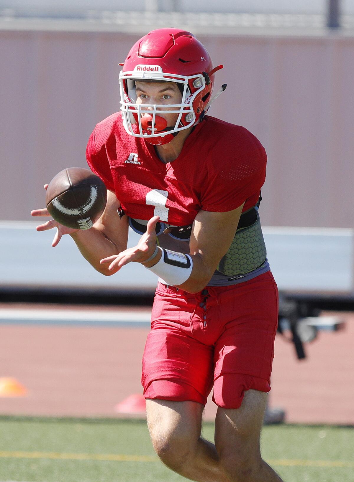 Burroughs' Aiden Forrester brings in a catch during a drill at football practice at Burroughs High School in Burbank on Tuesday, August 13, 2019.