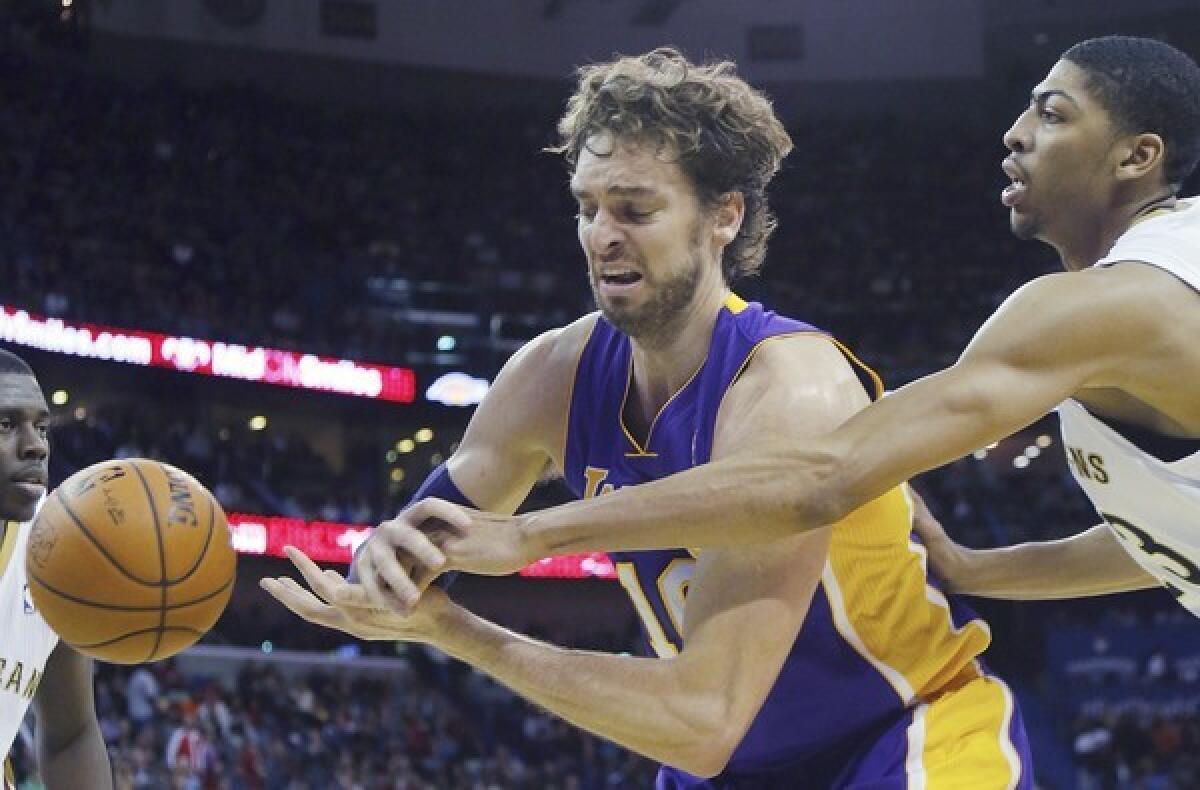 Pelicans forward Anthony Davis knocks the ball away from Lakers forward Pau Gasol during a 96-85 Lakers loss in New Orleans.