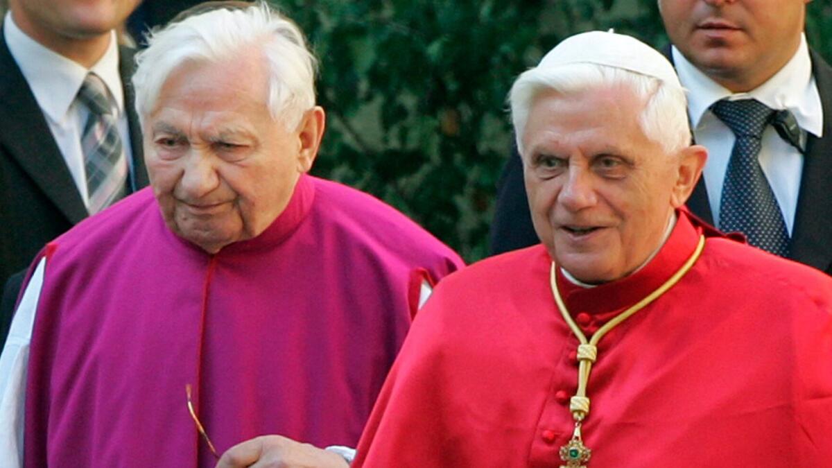 Pope Benedict XVI, right, walks with his brother Georg Ratzinger in Regensburg in southern Germany in 2006.
