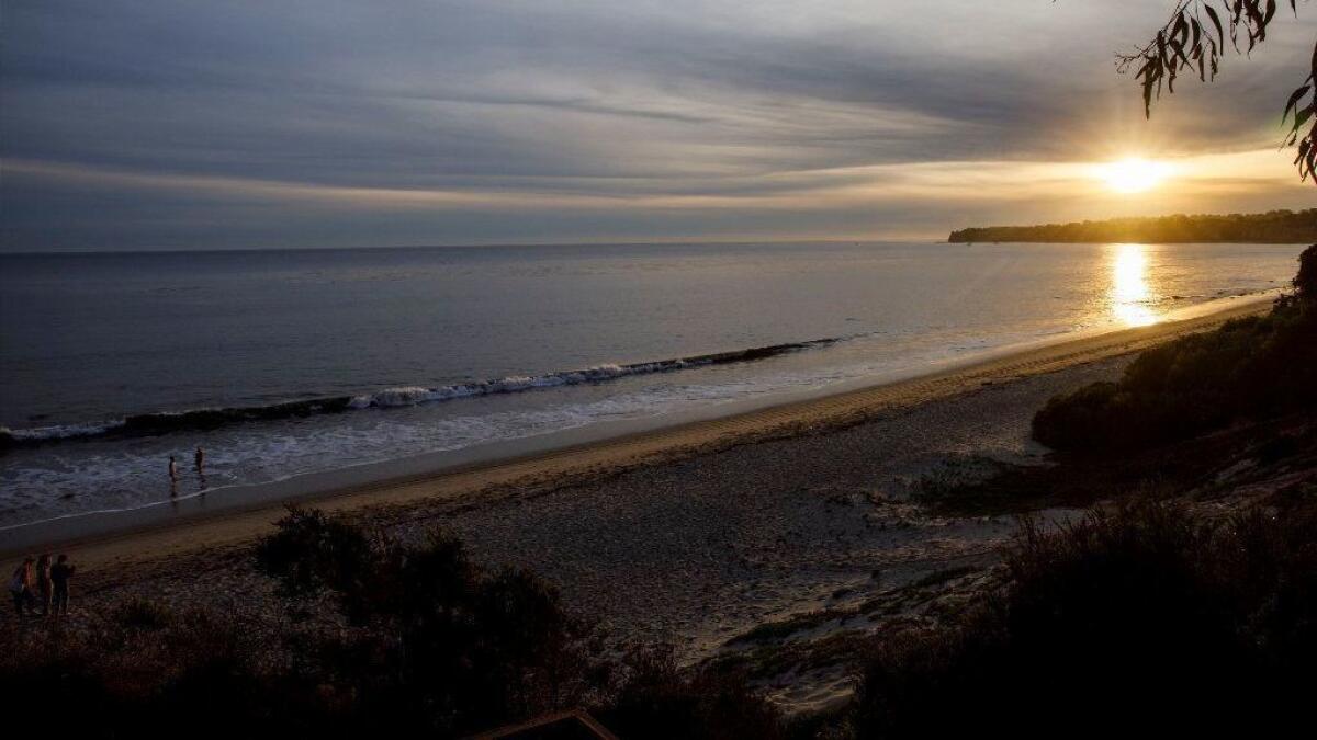 The sun sets along Malibu's Escondido Beach, accessible via an access pathway mandated by the California Coastal Commission.