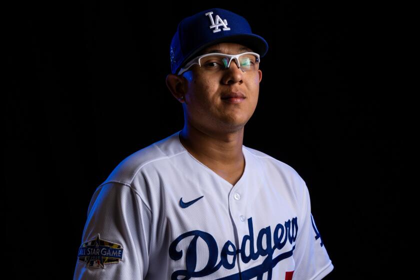 Dodgers pitcher Julio Urias (7) poses for a portrait during Spring Training photo day at Camelback Ranch on Feb. 20, 2020.