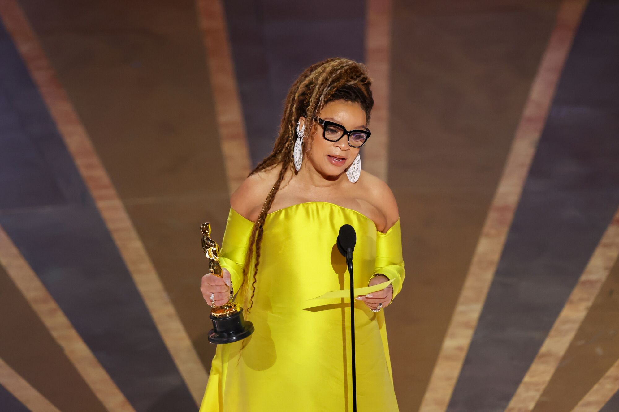 A woman accepts an award.