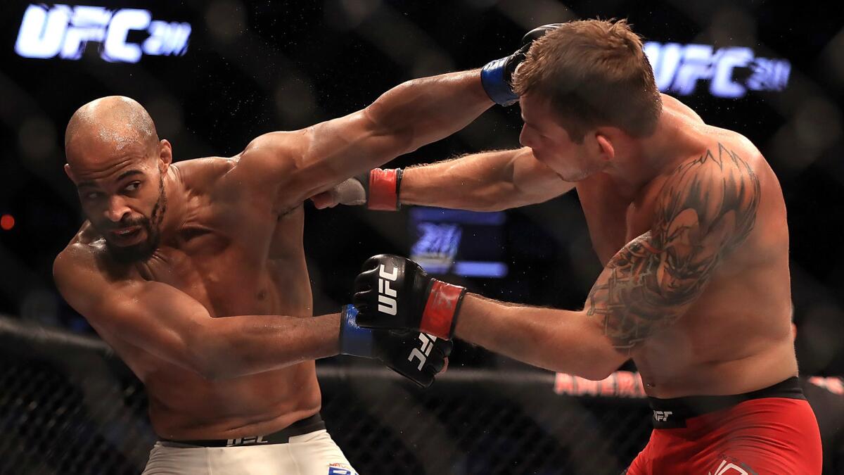 David Branch, left, and Krzysztof Jotko trade blow during their lightweight bout at UFC 211.