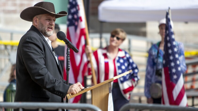 FILE - In this April 3, 2021 file photo Ammon Bundy speaks to a crowd of about 50 followers in front of the Ada County Courthouse, in downtown Boise. The anti-government activist has asked a judge to throw out the guilty verdict in his trespassing case and to acquit him instead because he says the state's trespassing law should not be applied to public property. Idaho's courts, like many states, allow defendants to ask the judge for an acquittal within several days of the jury verdict. (Darin Oswald/Idaho Statesman via AP, File)/