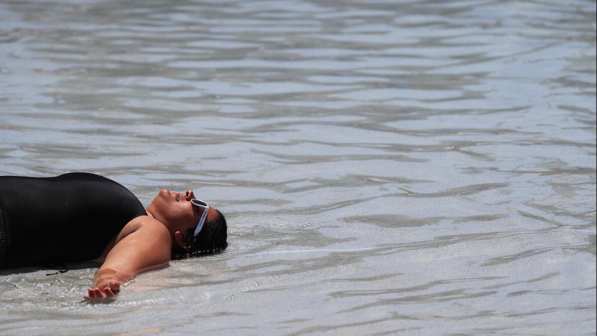 Shadwa Boctor of Huntington Beach tries to stay cool during a heat wave in July. Last year was the fourth-hottest year on record, according to new reports from NASA and the National Oceanic and Atmospheric Administration.