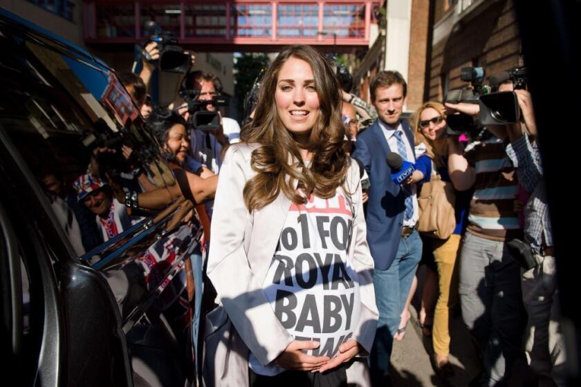 A lookalike of Catherine, Duchess of Cambridge, was among the crowd outside London's St. Mary's Hospital on Friday. Media are awaiting the birth of Will and Kate's new baby.