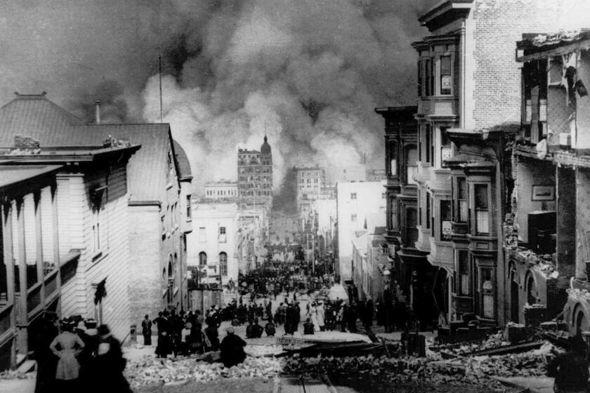 People on Sacramento Street watch smoke rise from fires after a severe earthquake in San Francisco, Calif., on April 18, 1906. (AP Photo/Arnold Genthe)
