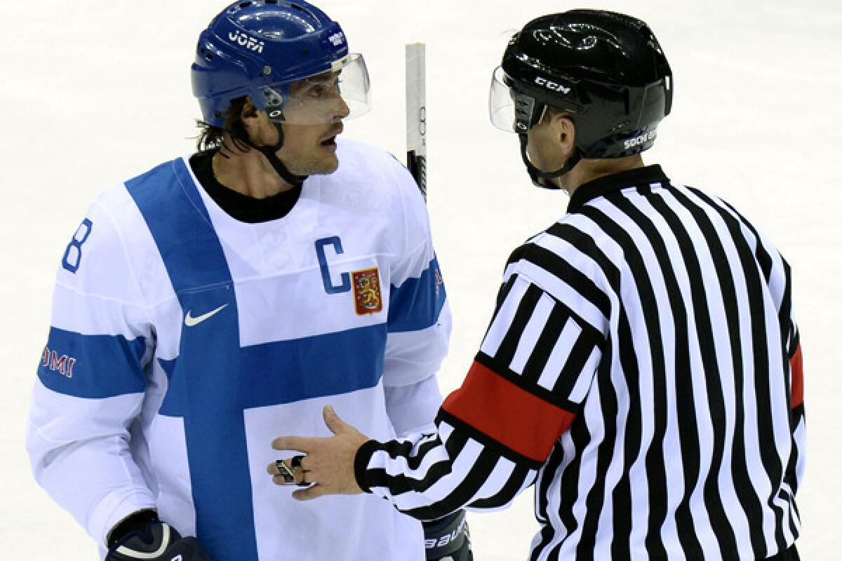 Finland captain Teemu Selanne argues with a referee during an 8-4 victory over Austria n a men's hockey group game.
