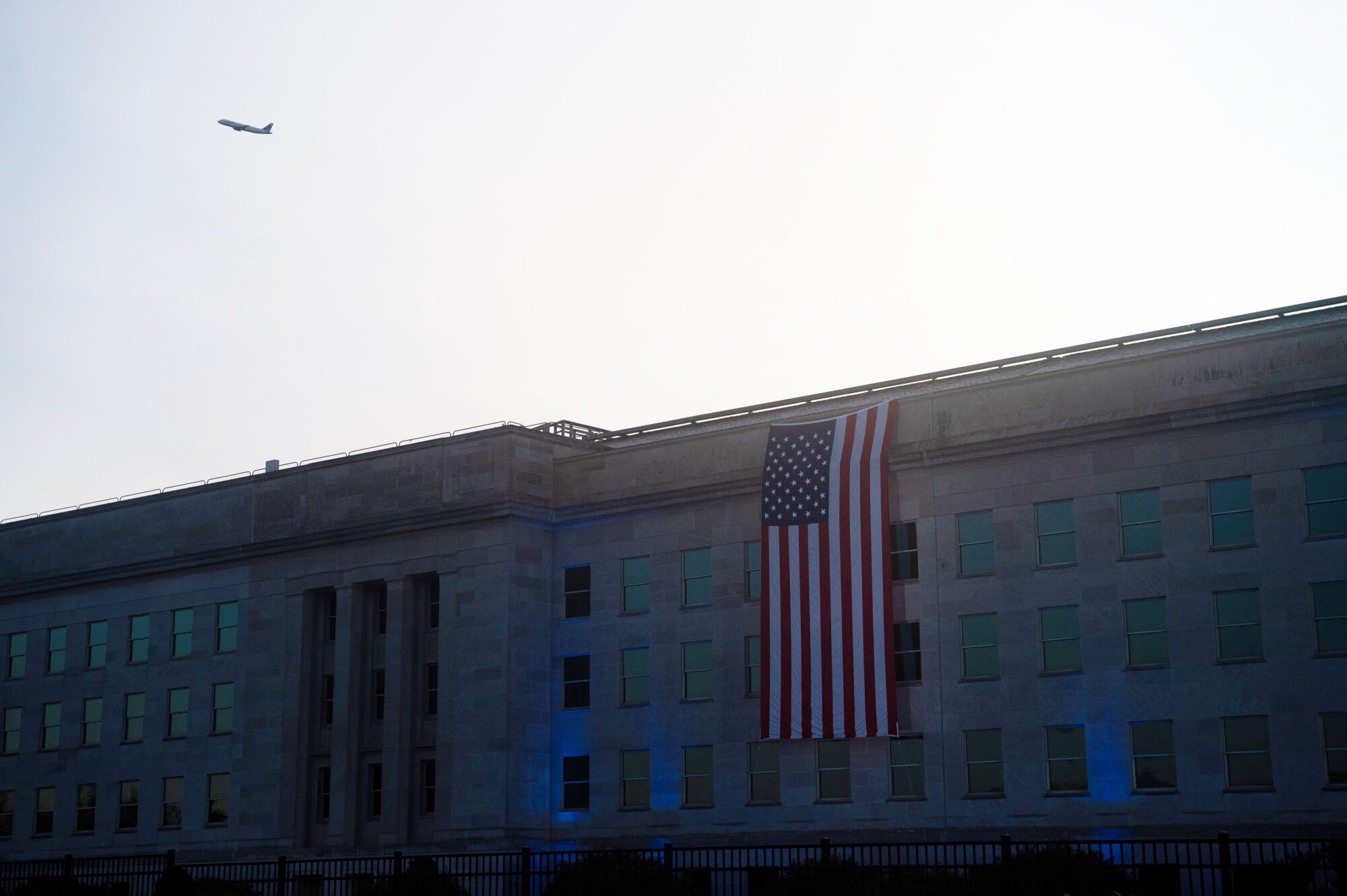 An American flag hangs from the outside of the Pentagon