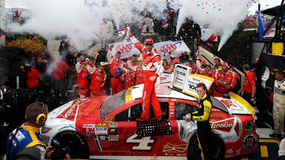 NASCAR driver Kevin Harvick celebrates after winning the Sprint Cup Series AAA 400 at Dover International Speedway on Sunday.