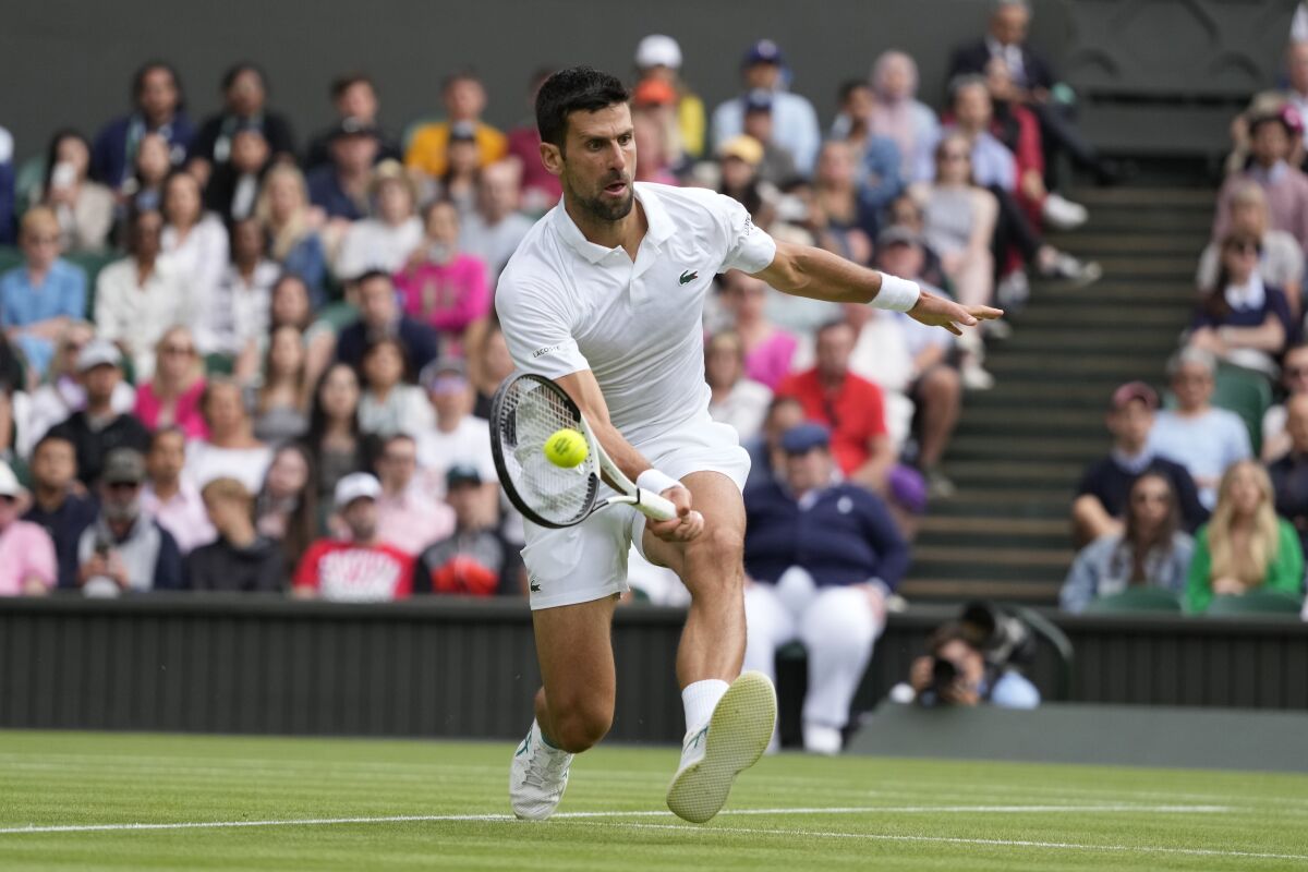 Novak Djokovic volleys a shot against Andrey Rublev on Tuesday at Wimbledon.