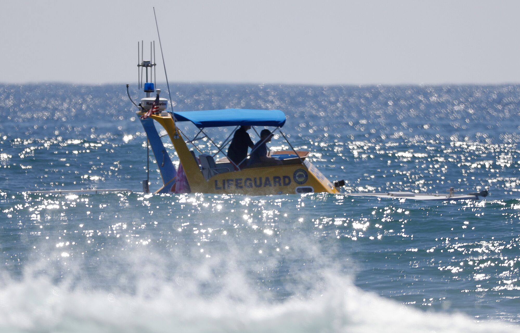 Lifeguards patrol the surf break as a shark sighting caused a delay at the World Surf League Finals at Lower Trestles.