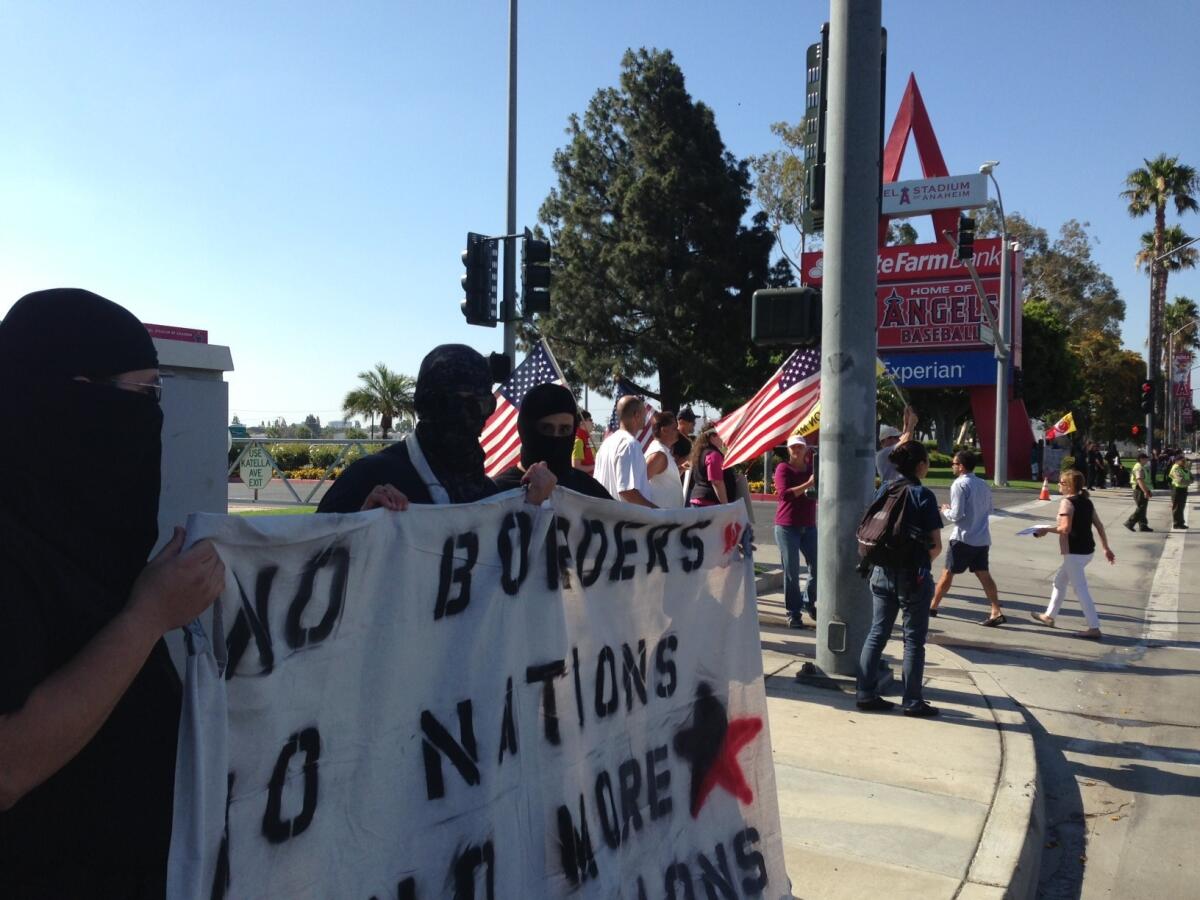 Demonstrators outside Angel Stadium included those protesting President Obama's deportation policies.