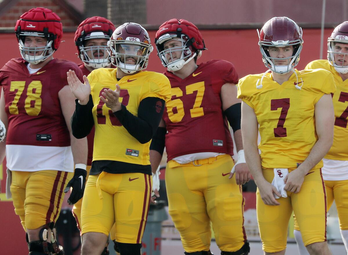 USC quarterback Caleb Williams and backup Miller Moss warm up during a spring practice session.