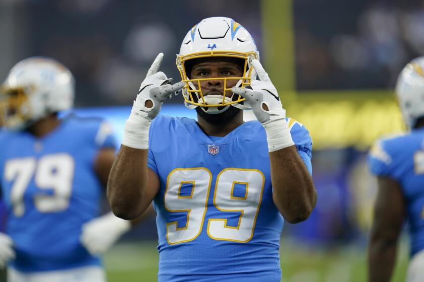 Los Angeles Chargers defensive lineman Jerry Tillery (99) warms up before an NFL football game against the Los Angeles Rams Tuesday, Aug. 16, 2022, in Inglewood, Calif. (AP Photo/Ashley Landis)