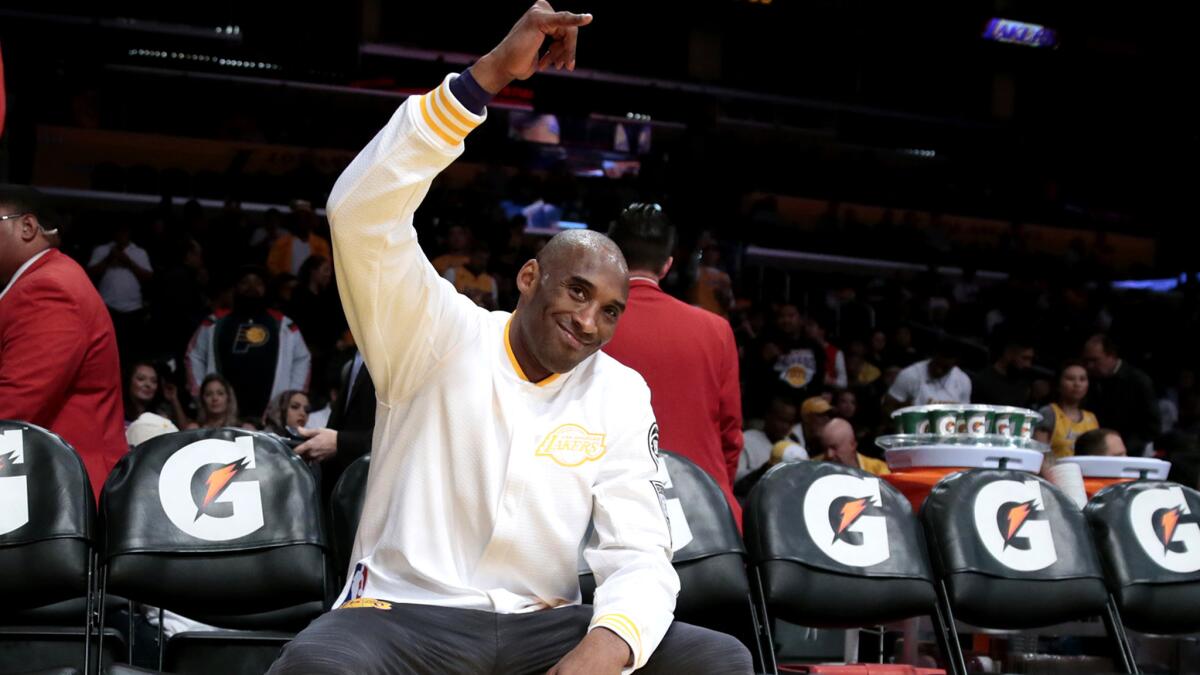 Kobe Bryant waves to fans during warmups before a game at Staples Center.