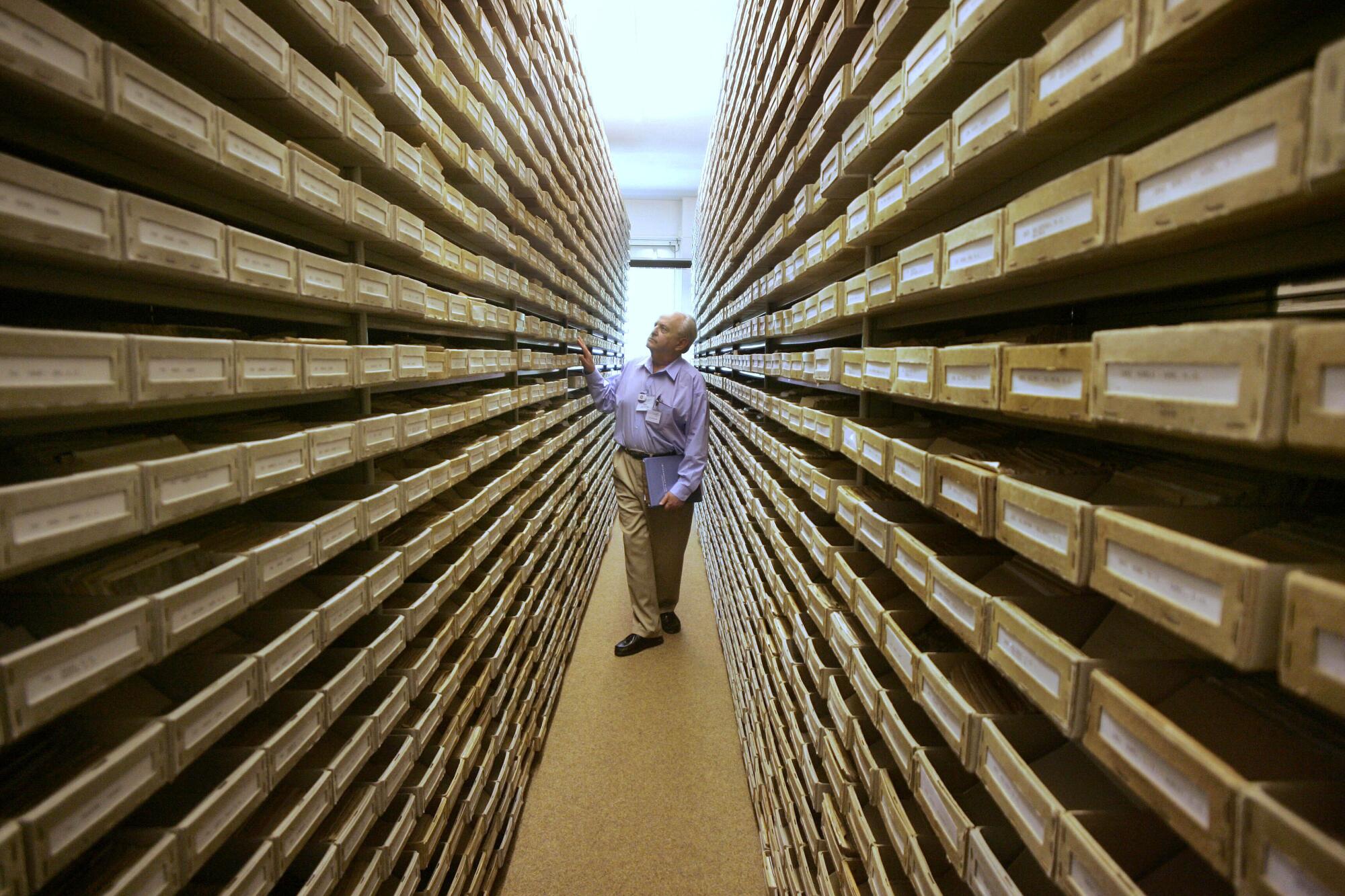 Gary Mokotoff, a Jewish genealogist from New Jersey, checks name registers at a Holocaust center in Bad Arolsen, Germany.