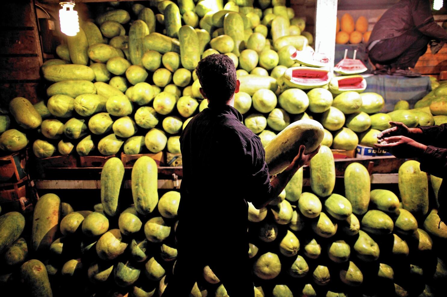 ISTANBUL,TURKEY-JUNE 7:Guys slicing watermelon to sell at their