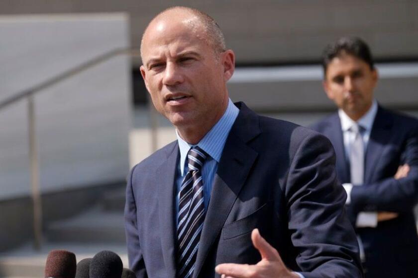 FILE - In this July 27, 2018 file photo, attorney Michael Avenatti replies to questions by reporters during a news conference in front of the U.S. Federal Courthouse in Los Angeles. U.S. prosecutors announced Monday, March 25, 2019, they have charged Avenatti with extortion and bank and wire fraud. A spokesman for the U.S. attorney in Los Angeles said Avenatti was arrested Monday in New York. (AP Photo/Richard Vogel, File)