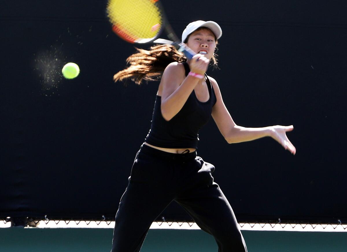 Huntington Beach High's Yen Nhi Huynh returns a serve during the CIF Individuals tournament in Claremont on Wednesday.