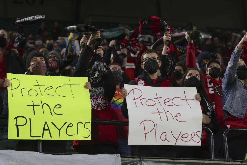 Portland Thorns fans hold signs during a National Women's Soccer League soccer match against the Houston Dash