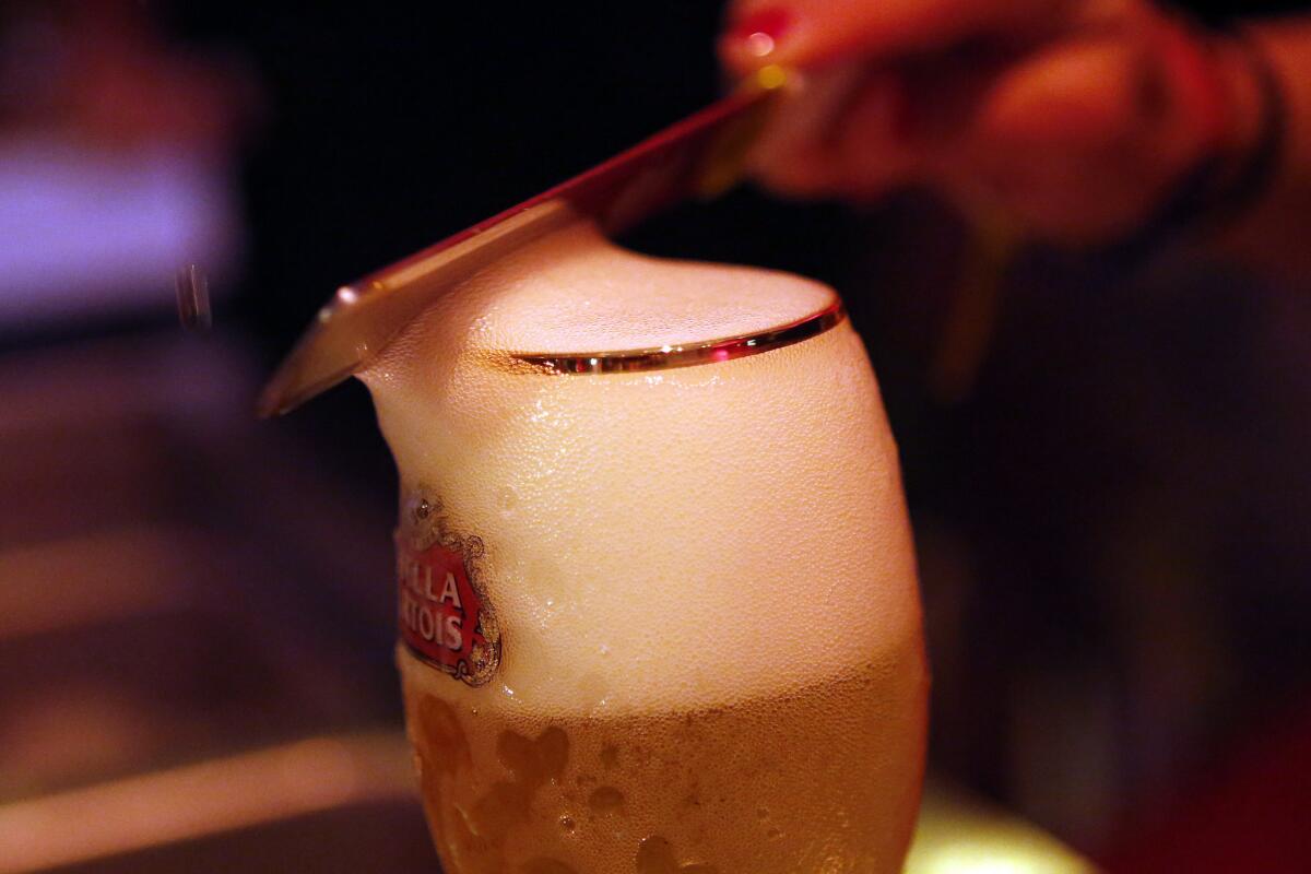 A Stella Belgian beer is "beheaded" of its foam.