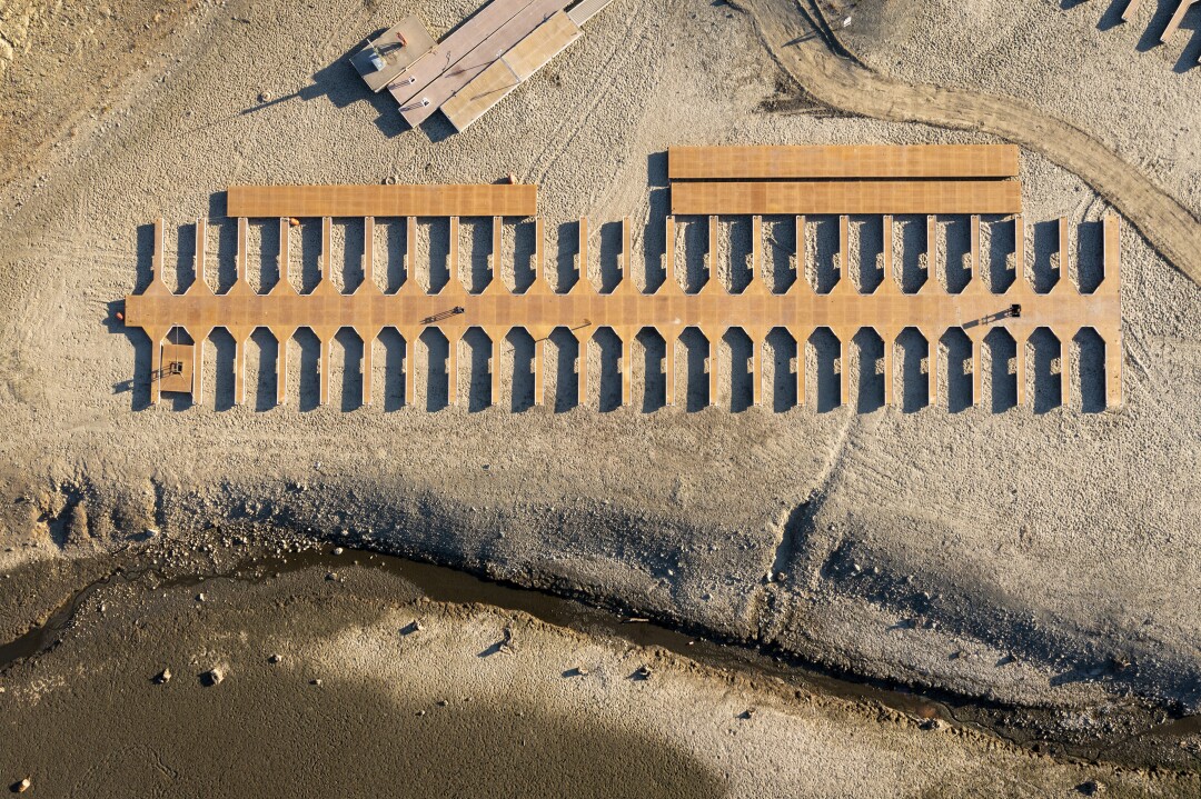 Boat slips lay stranded on dry land as water levels recede.