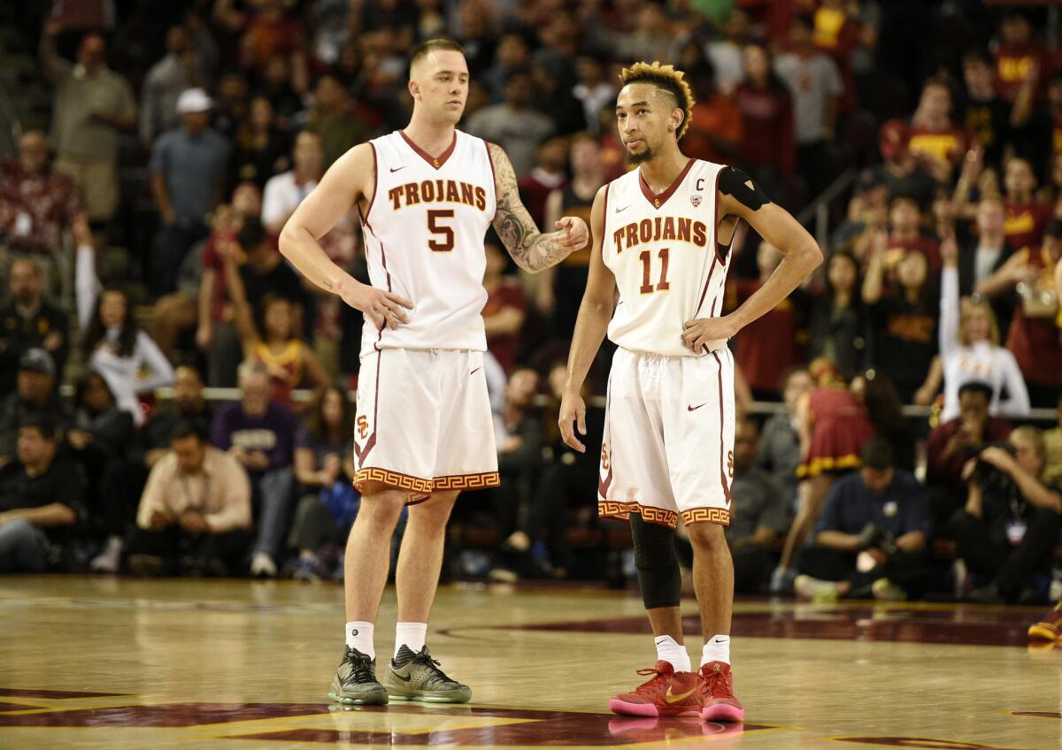 USC guards Katin Reinhardt (5) and Jordan McLaughlin (11) talk during the second half of a game against Washington.
