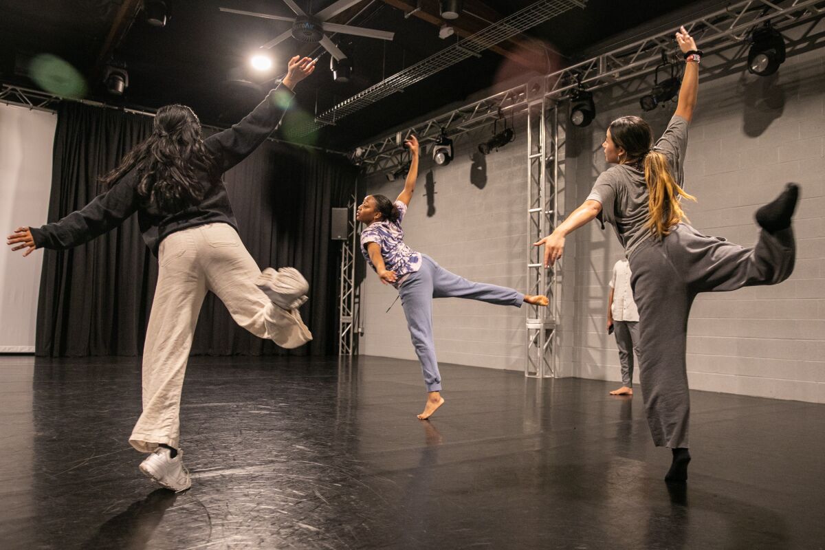 A choreographer works with dancers during a rehearsal.