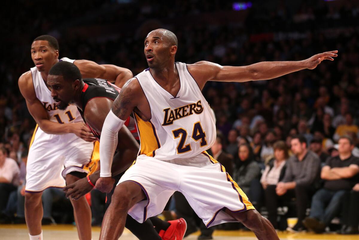 Lakers guard Kobe Bryant and forward Wesley Johnson try to box out Raptors forward Patrick Patterson on a free-throw attempt during their Nov. 30 game at Staples Center.