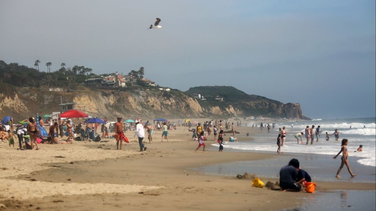 Crowds gather at Zuma Beach in Malibu on a warm day in June. A report released by Heal the Bay on Thursday gave the beach a failing grade in water quality.