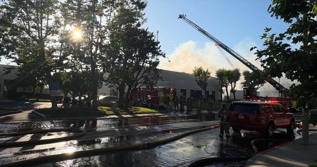 Costa Mesa fire crews responded Sunday evening to a three-alarm fire at an industrial building on Cadillac Avenue.