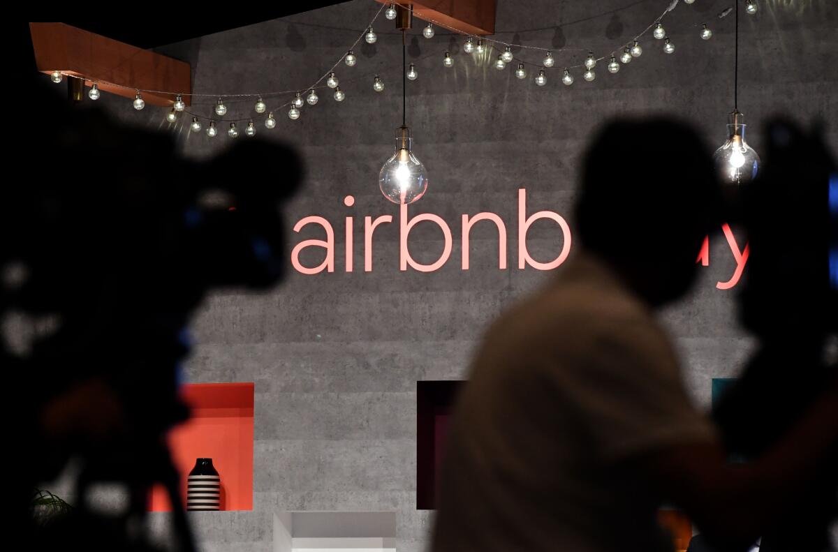 The logo of the U.S. rental site Airbnb is displayed during the company's press conference in Tokyo.