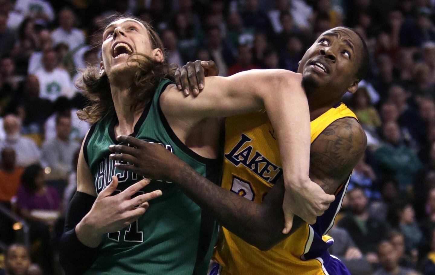 Celtics center Kelly Olynyk tries to hold his rebounding position against Lakers forward Ed Davis in the second half.