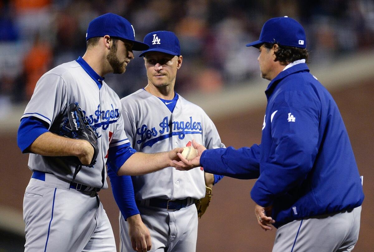 Dodgers Manager Don Mattingly, right, takes reliever Paco Rodriguez out of the game as teammate Mark Ellis looks on during the eighth inning of the Dodgers' 3-2 loss Thursday to the San Francisco Giants.