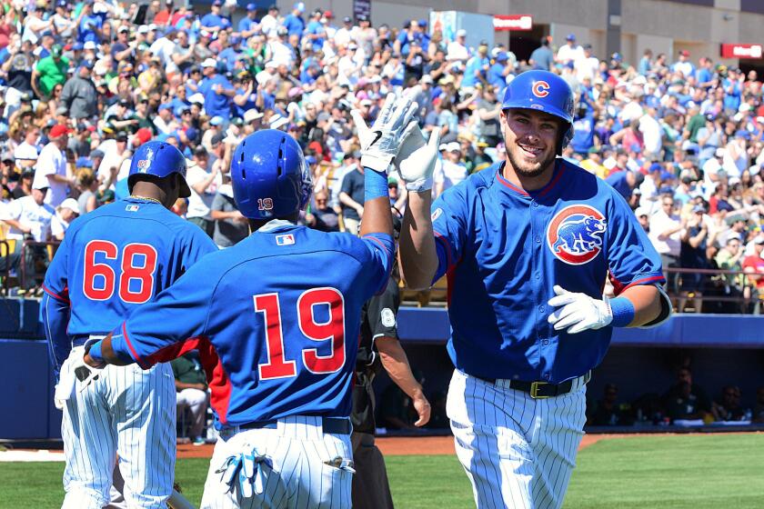 Kris Bryant is likely all smiles, as seen here, as he will make his major league debut with the Cubs after being promoted.