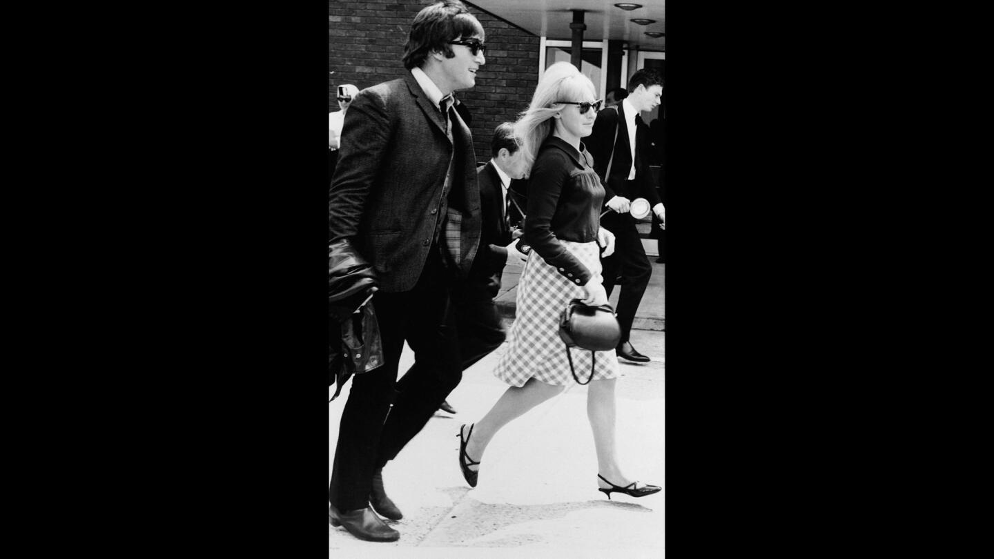 John Lennon and wife Cynthia after the Beatles arrived home in London from their three-week tour of Australia and New Zealand on July 2, 1964.