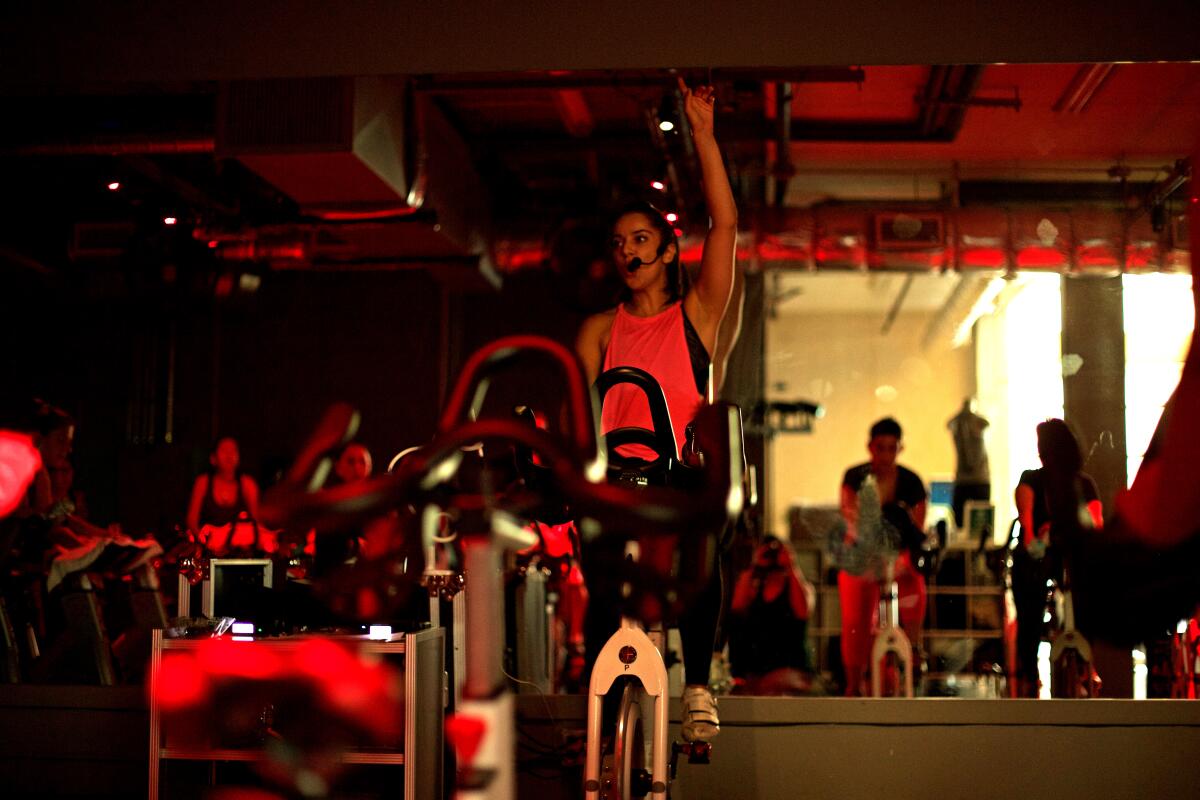 Cyclists work out at Rev Cycle inside before the pandemic.