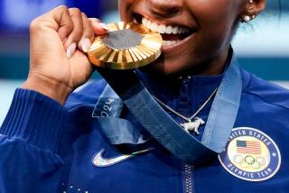 Simone Biles, of the United States, celebrates after winning the gold medal during the women's artistic gymnastics all-around finals in Bercy Arena at the 2024 Summer Olympics, Thursday, Aug. 1, 2024, in Paris, France. (AP Photo/Abbie Parr)