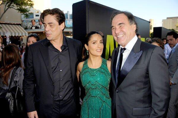 Actors Benicio Del Toro, left, Salma Hayek and director Oliver Stone arrive at the premiere of "Savages." Director Oliver Stone's "Savages" takes place in Laguna Beach, where young entrepreneurs Ben and Chon create a lucrative marijuana business. When Mexican drug cartel Baja Cartel asks for a partnership and is denied, kidnapping and violence follow. Click through the gallery to see photos from the premiere at Westwood Village.