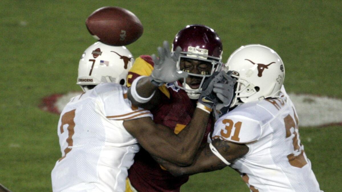 USC's Reggie Bush tries to lateral the ball to Brad Walker, resulting in a fumble during the second quarter of the BCS championship game against Texas on Jan. 4, 2006.