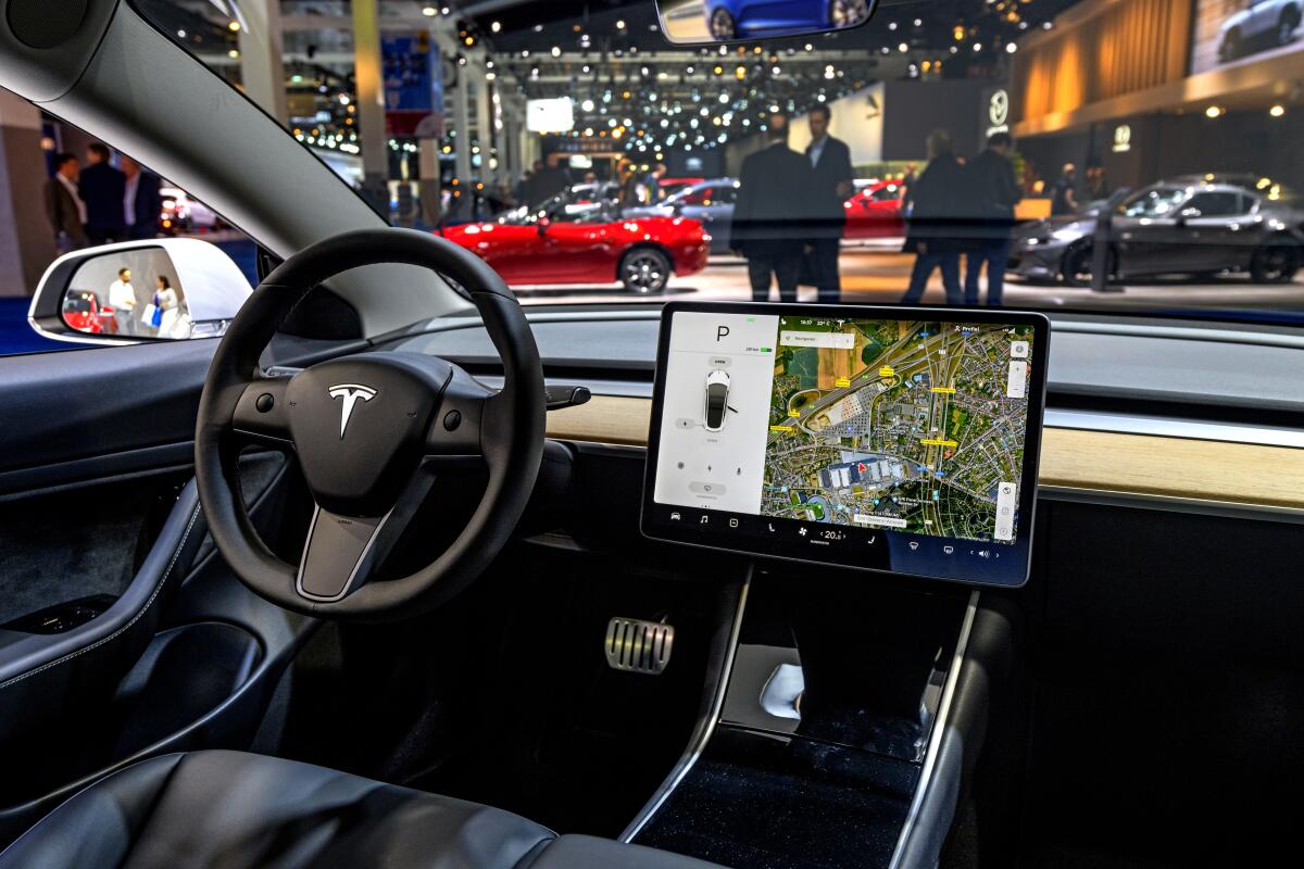 A large control screen dominates the dashboard of a Tesla Model 3 on display in Belgium in 2020. 