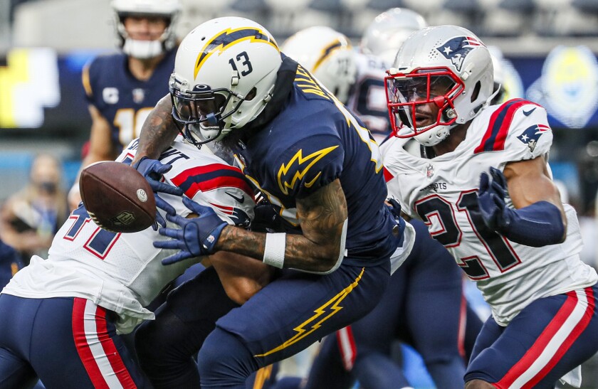 Chargers wide receiver Keenan Allen loses the ball after being hit by New England Patriots cornerback Myles Bryant.