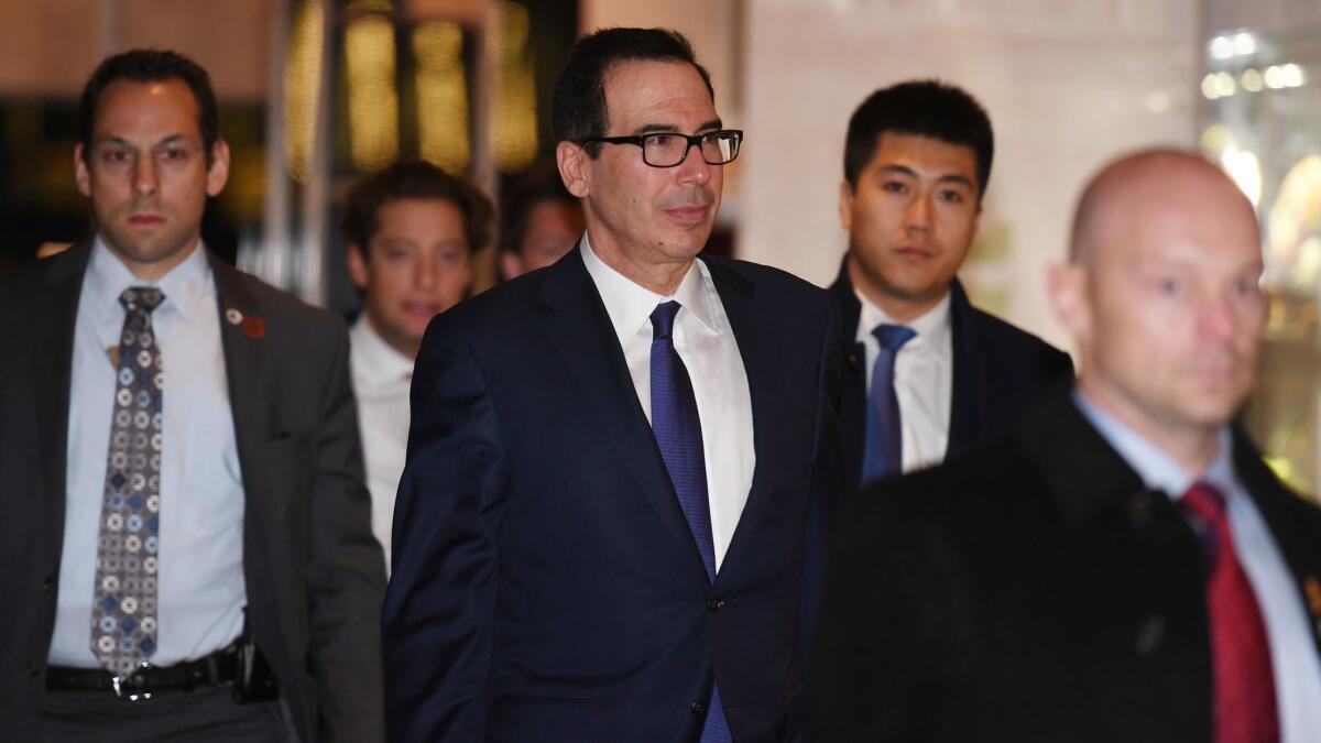 U.S. Treasury Secretary Steven T. Mnuchin returns to a hotel with members of his negotiation team Feb. 14 after trade talks in Beijing.