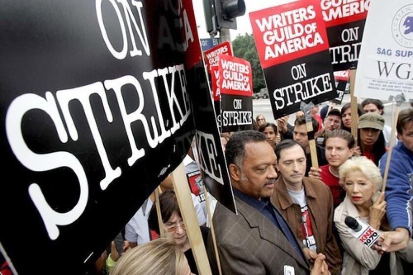 SUPPORT: The Rev. Jesse Jackson, from left, visits the picket line at Paramount Pictures with WGA President Patric M. Verrone and France Nuyen, a national board member of the Screen Actors Guild.